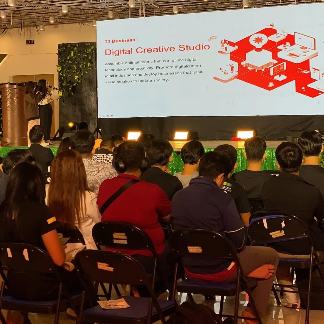 A Sun* Philippines speaker presenting the Digital Creative Studio offering to a seated audience at a business seminar.