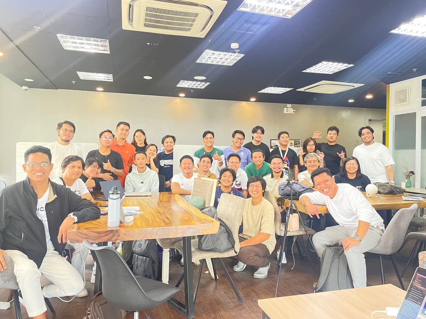 Team members gathered around a shared table at the Cebu office during the workday.