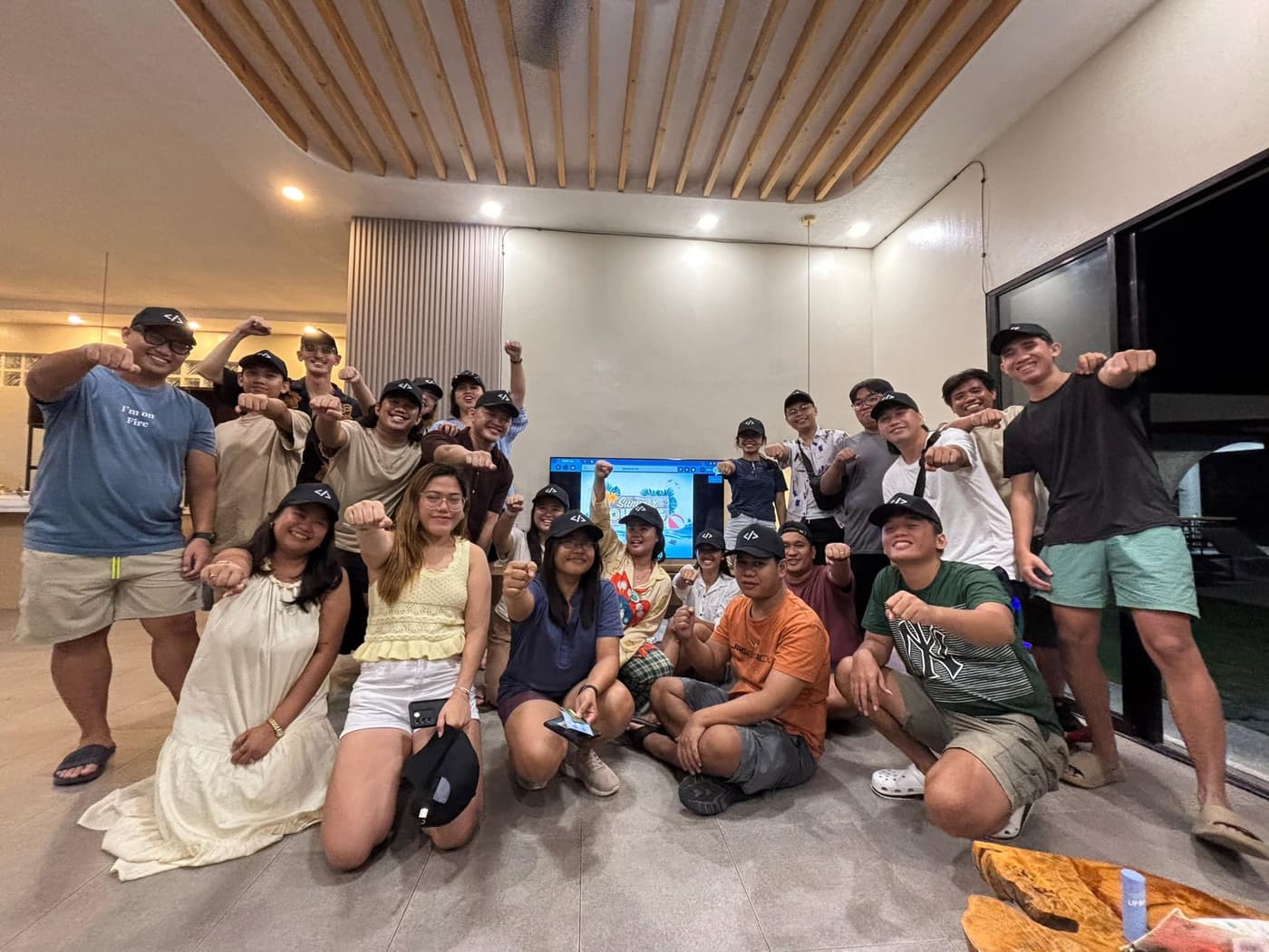 Team members celebrating together indoors during a summer outing.