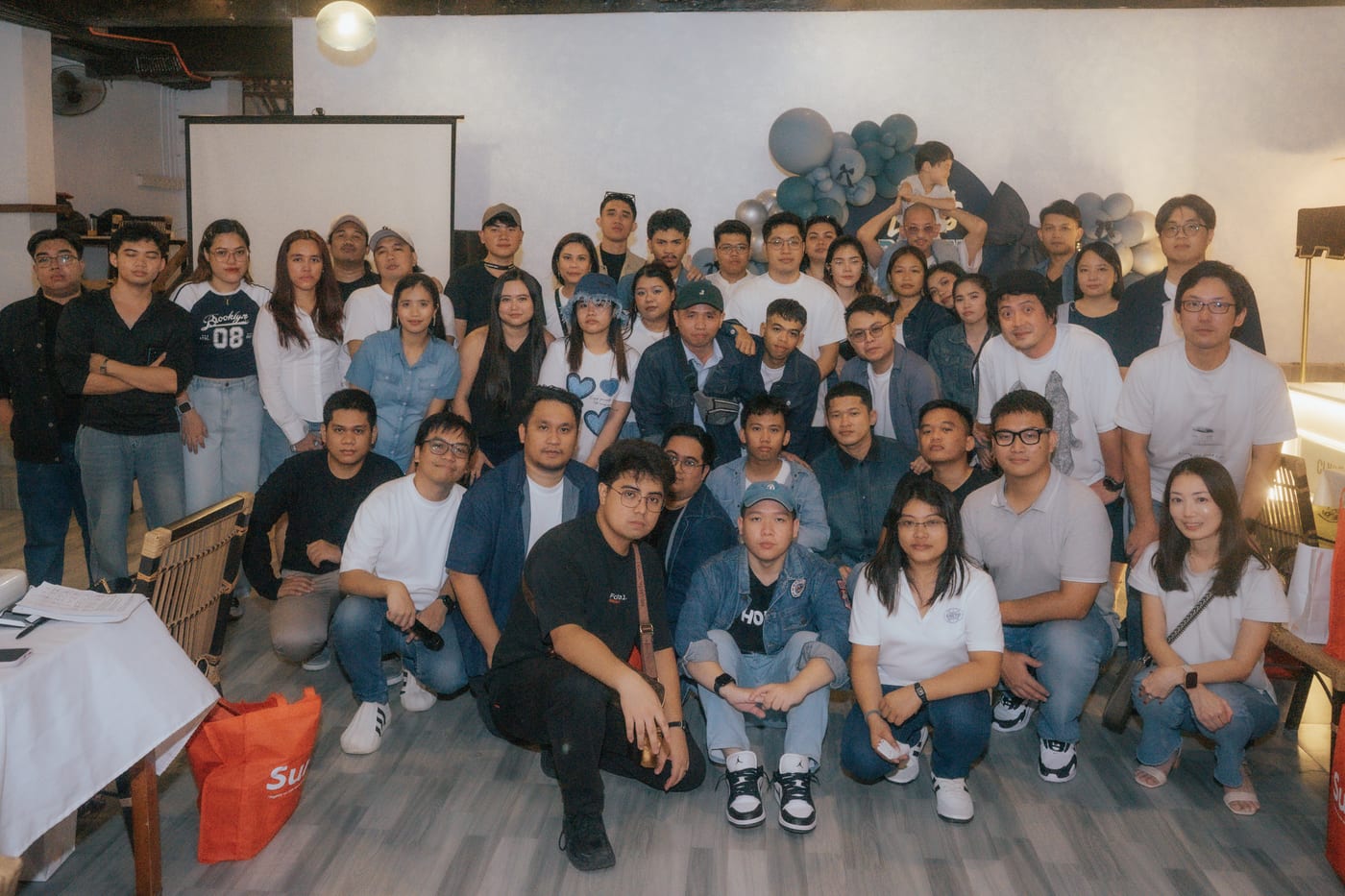 The full Sun* Philippines team gathered for a group photo at a team get-together, dressed in denim and white.